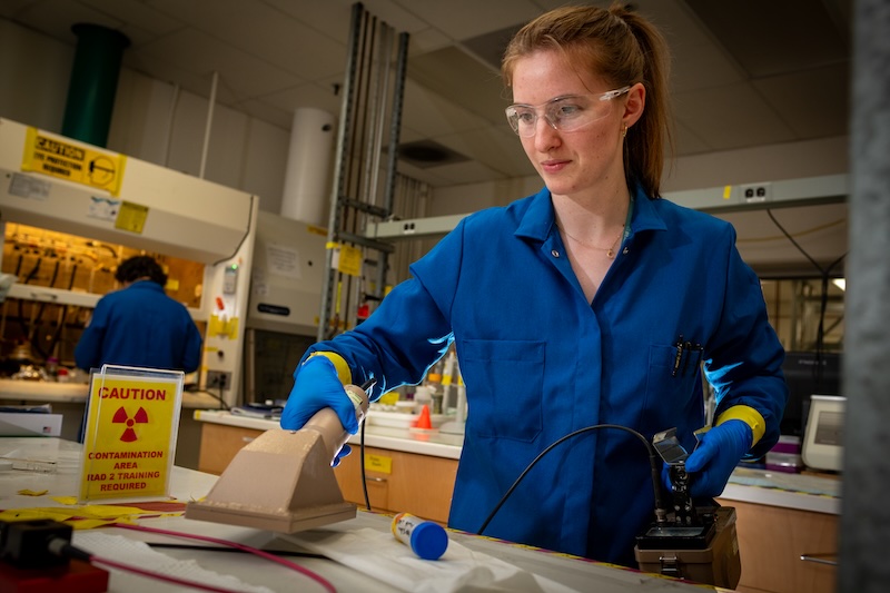 Megan Schiferl, Student Intern, Nuclear Science Division, tests a lab bench in Building 70 A for any residual radioactive particles to ensure the safety of everyone who works in the lab at Lawrence Berkeley National Laboratory (Berkeley Lab), 04/02/2024.