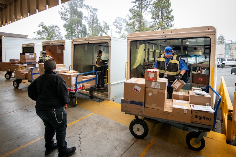 Benjamin Martinez (right), Facilities Division Truck Driver, unloads boxes at Lawrence Berkeley National Laboratory’s Shipping & Receiving facility, 09/09/2025